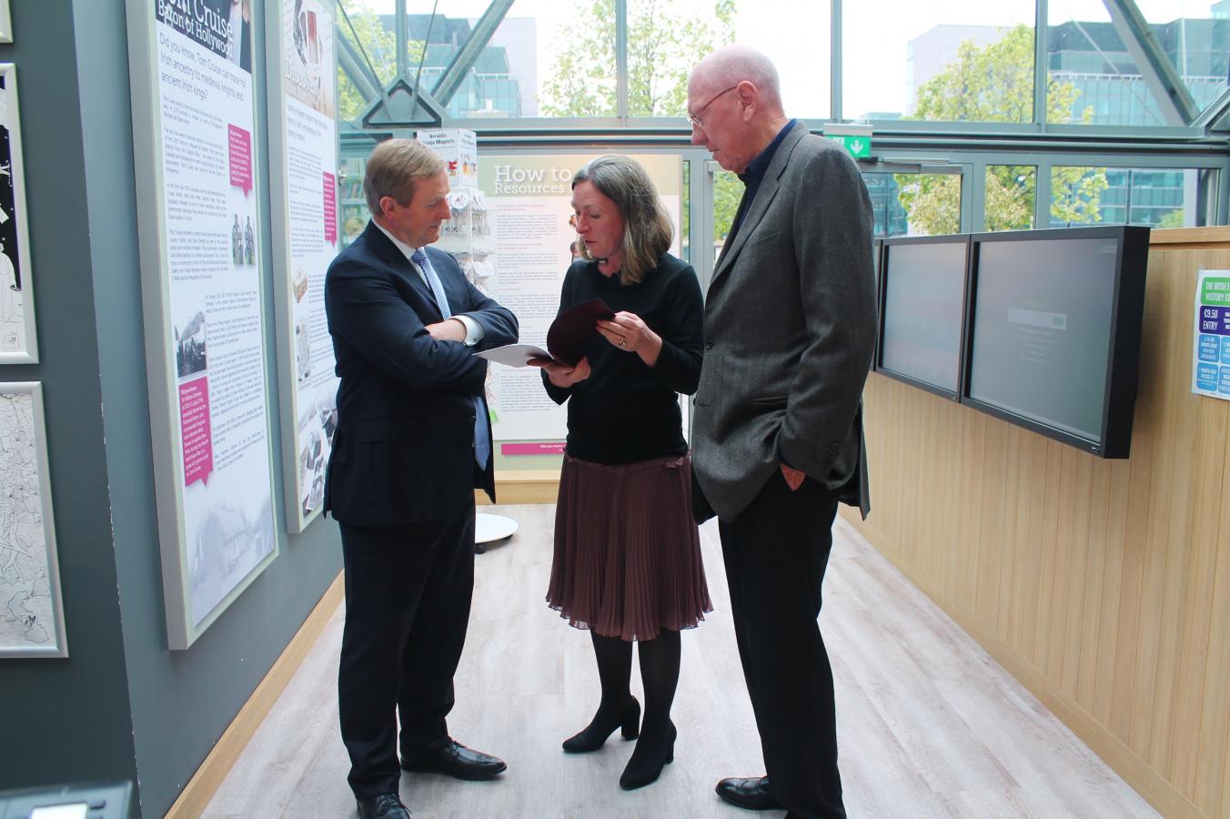 Enda Kenny is presented with his Family History by Fiona Fitzsimons accompanied by Nevill Isdell 