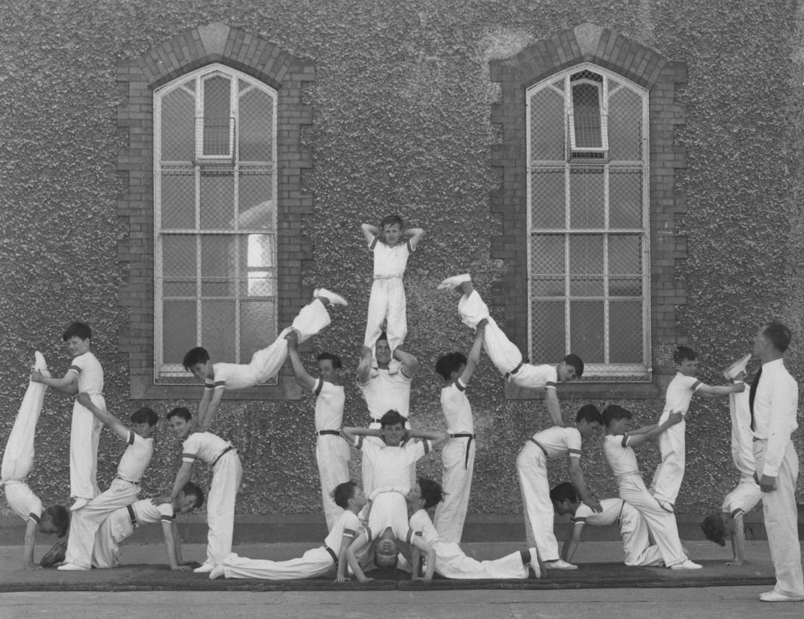 boys doing a gymnastic display with their instructor Mr. J. Kavanagh