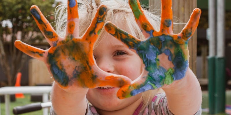 kids with paint in hand