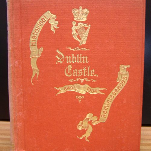 photo of an orange book cover with the following text in gold, stylised font "Historical Reminiscences Dublin Castle 849 - 1904" and an image of a harp underneath a crown